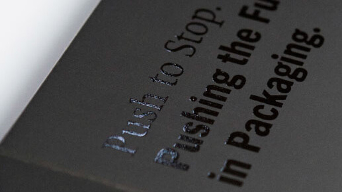 Black cardboard with black glossy writing