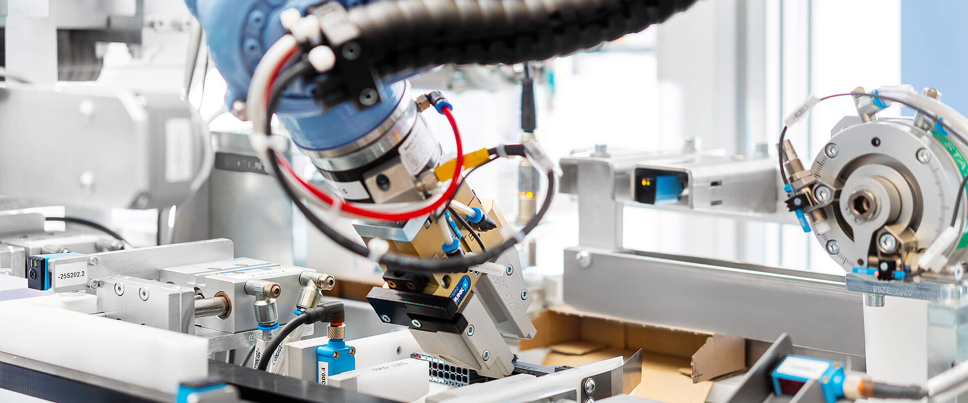 Close up of a packaging machine with a robot arm