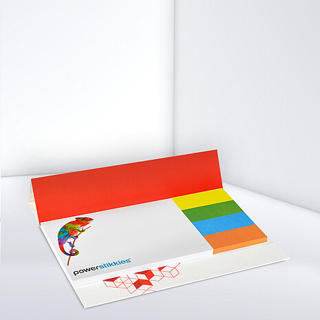 White adhesive note pad with four multi-coloured paper markers on cardboard
