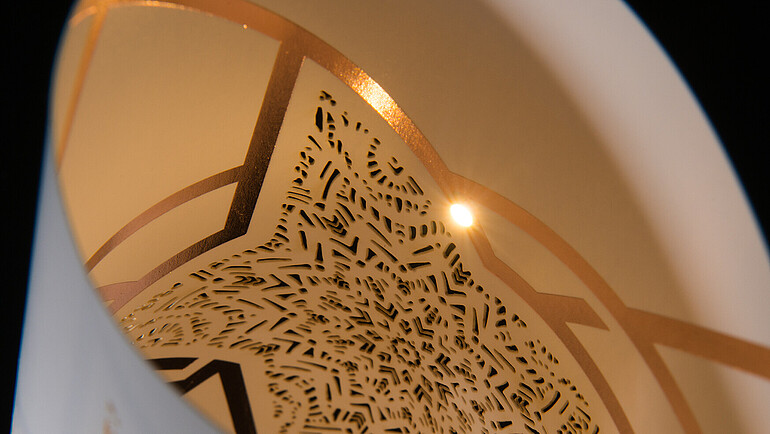 White cardboard with perforated pattern and lighting