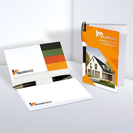 Two white adhesive note pads with four multi-coloured paper markers and ballpoint pen in printed cardboard cover