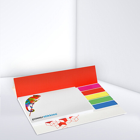 White adhesive note pad with five multi-coloured plastic markers on cardboard