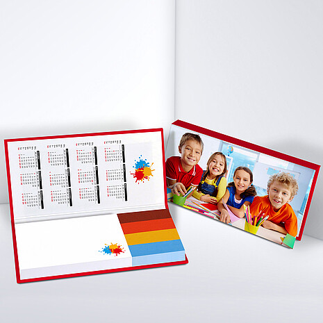 White adhesive note pad with four multi-coloured paper markers in printed hard cover with calendar print